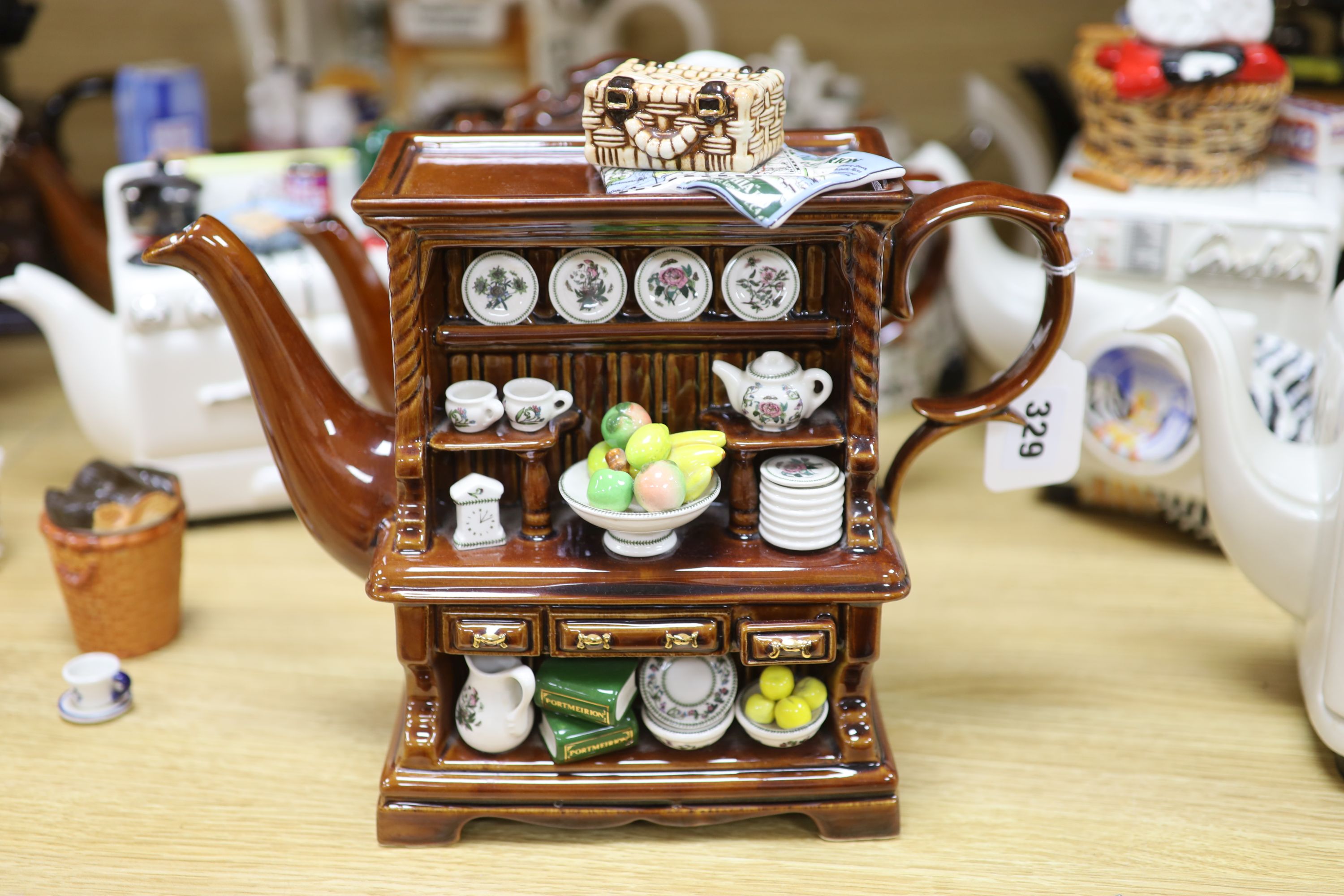 A collection of thirteen Portmeirion and Cardew novelty teapots, including dresser, sewing machine and kitchen range examples